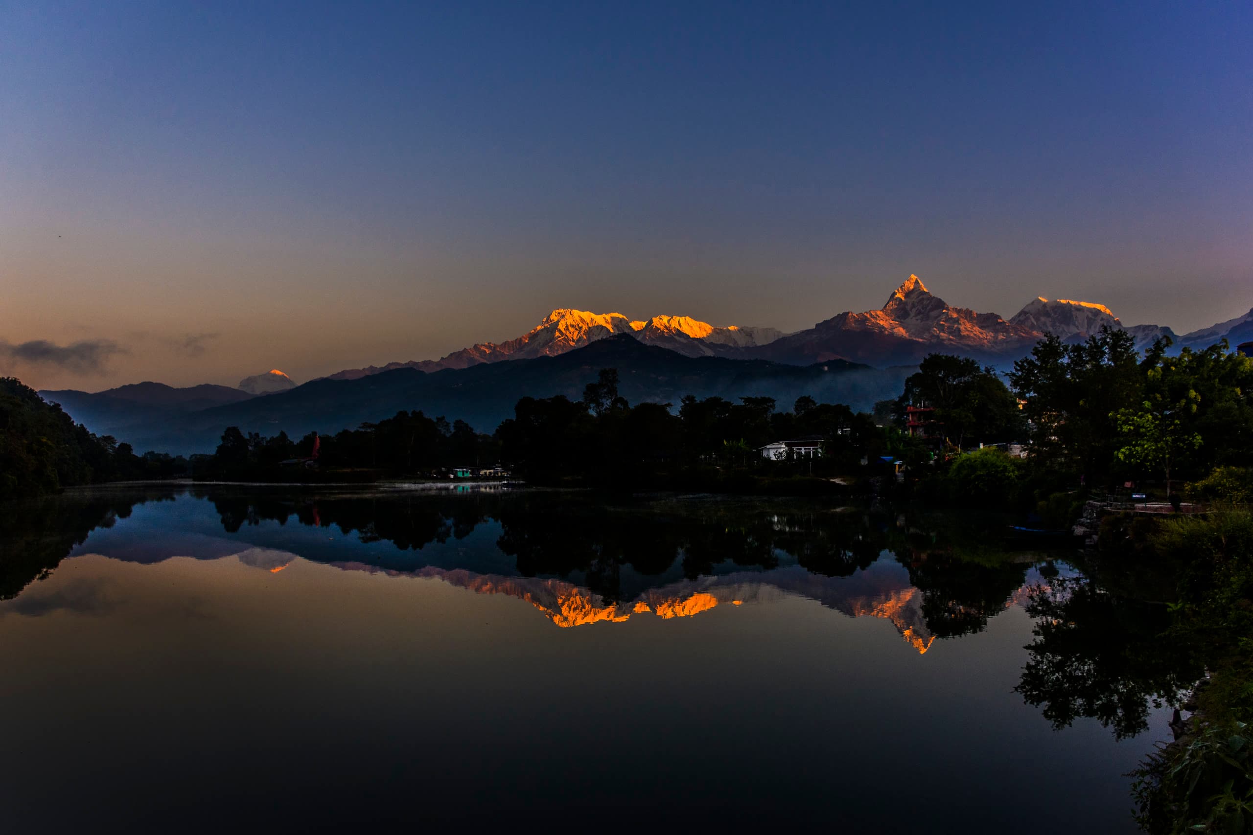 Phewa Lake mirror reflection of Annapurna and Machapuchare mountain peaks at first light